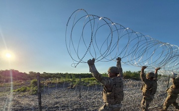 The 350th Engineer Company installs triple-standard concertina wire