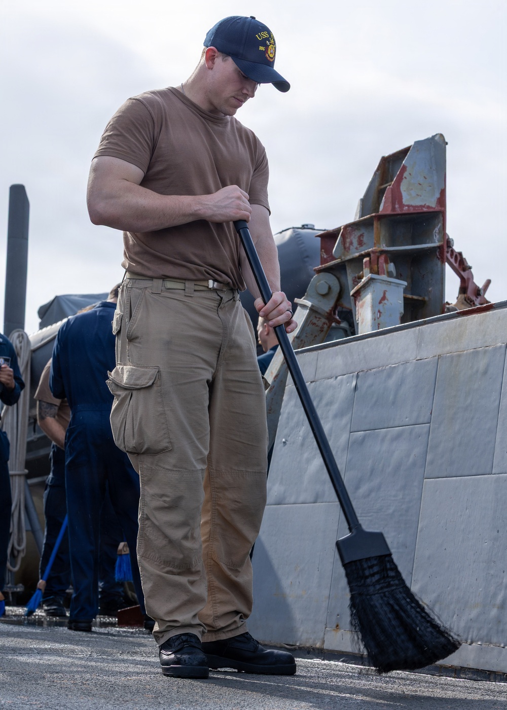 Sailor Sweeps Deck Aboard USS Ross (DDG 71)