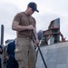 Sailor Sweeps Deck Aboard USS Ross (DDG 71)