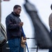 Sailor Sweeps Deck Aboard USS Ross (DDG 71)