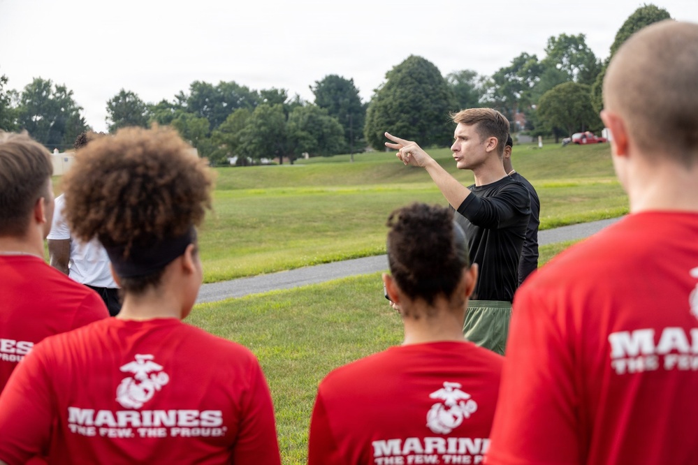 Marine Corps recruiter briefs POOLEES during physical training session