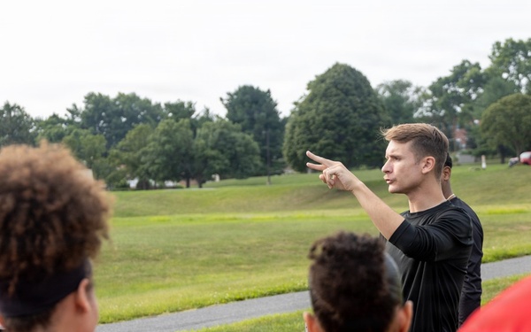 Marine Corps recruiter briefs POOLEES during physical training session