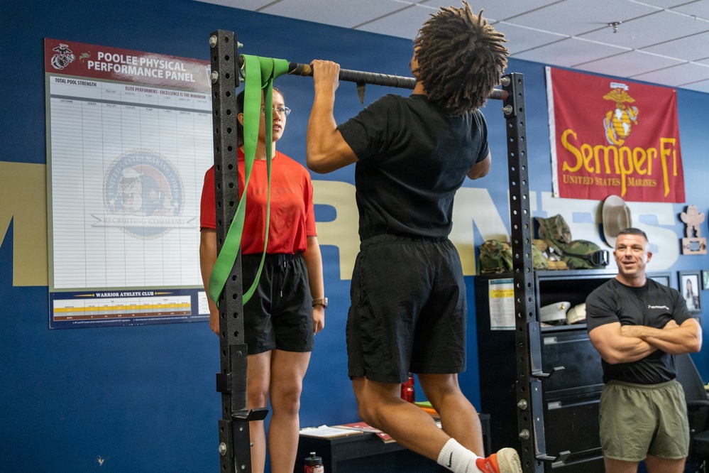 Marine Corps Applicant Conducts Pull-Ups at Recruiting Sub-Station During Physical Fitness Training