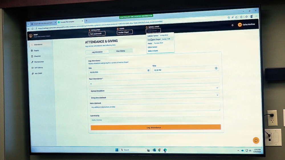 The image shows a computer monitor displaying a military chapel administration platform called 'CHAP' (Chapel Administration Platform). The screen shows an 'Attendance &amp; Giving' form for logging service attendance at Frontier Chapel, Fort Leavenworth. A dropdown menu for selecting a service/event is open, showing options including Catholic Service, CrossRoads Chapel, PWOC, Other Service, and Write-in Event.
