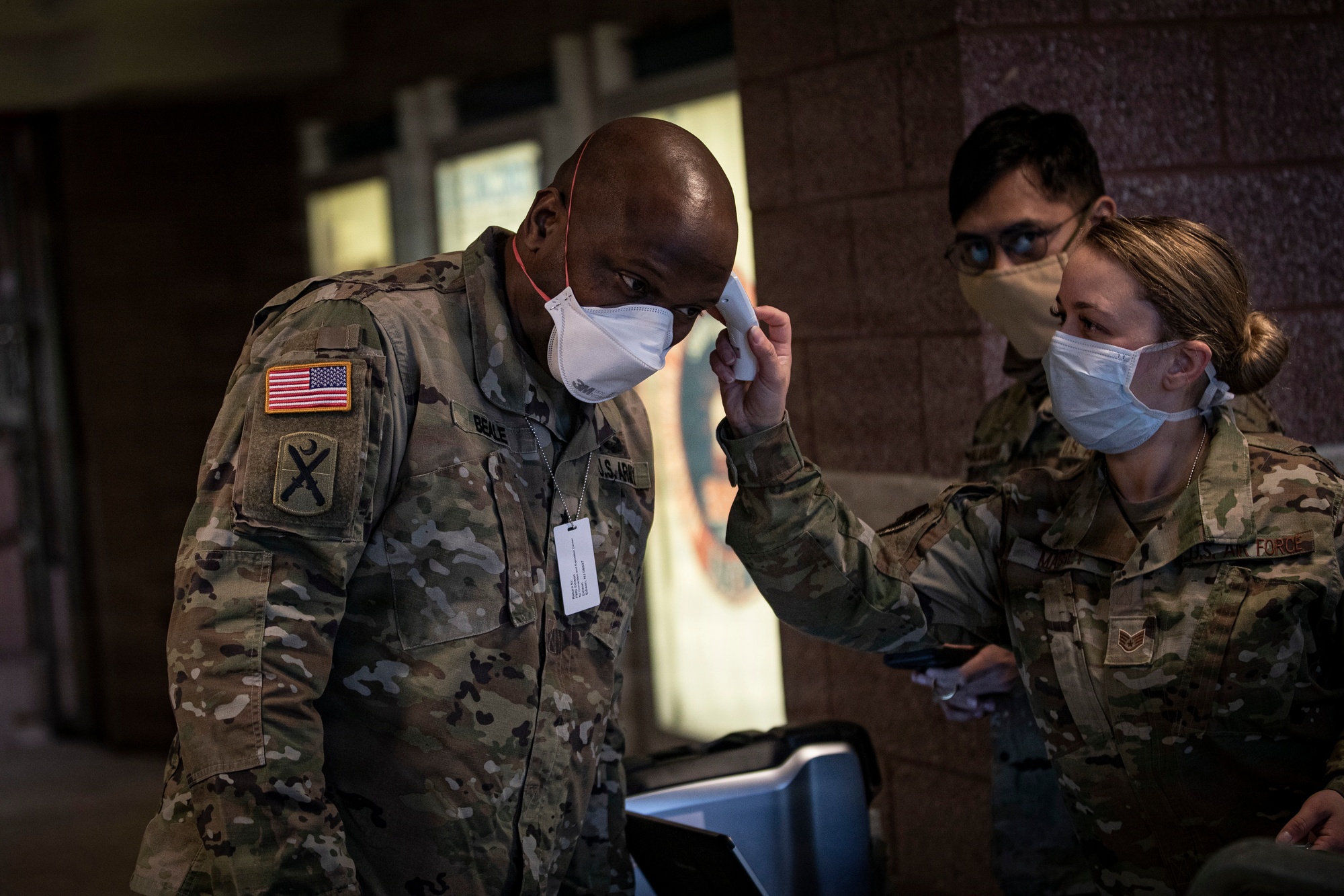 U.S. Army Brig. Gen. Jemal J. Beale, the Adjutant General of New Jersey, has his temperature taken by Air Force Staff Sgt. Samantha Massey at the entry control point for the Federal Medical Station inside the Atlantic City Convention Center, Atlantic City, N.J., April 21, 2020. The station was developed in conjunction with numerous organizations, including the FEMA, the U.S. Army Corps of Engineers, the Department of Health, the Office of Emergency Management, and the New Jersey National Guard. It is the third Federal Medical Station in the state, designed to ease the burden on local hospitals responding to the COVID-19 outbreak. (U.S. Air National Guard photo by Master Sgt. Matt Hecht)