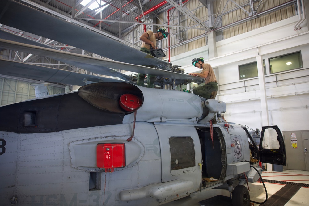 HSM-37 Sailors conduct helo maintenance
