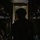 Preparing to Save Lives: CJTF - HOA Medics Conduct MASCAL Exercise A silhouetted soldier wearing a combat helmet is positioned in a narrow, dark corridor or passageway, likely inside a military vehicle or facility. The figure is backlit by a greenish light source ahead, creating a strong silhouette effect. Military equipment including weapons and gear are visible on racks or shelving on both sides of the corridor.