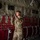Preparing to Save Lives: CJTF - HOA Medics Conduct MASCAL Exercise A female military service member in MultiCam/OCP camouflage uniform is standing inside what appears to be a military transport aircraft, likely a C-130 or similar cargo plane. She is reaching upward, possibly inspecting or adjusting equipment along the aircraft's interior wall. The interior features characteristic red troop seating webbing, static line cables, and instructional placards mounted on the fuselage wall.