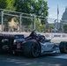 An IndyCar race car numbered 60, sponsored by Texas A&amp;M University and bearing 'A Force for Good' livery, navigates a street circuit in Washington D.C. The U.S. Capitol building is clearly visible in the background, identifying this as the former IndyCar Grand Prix on the Streets of Washington D.C. Trackside barriers display Boeing sponsorship branding alongside distance markers.
