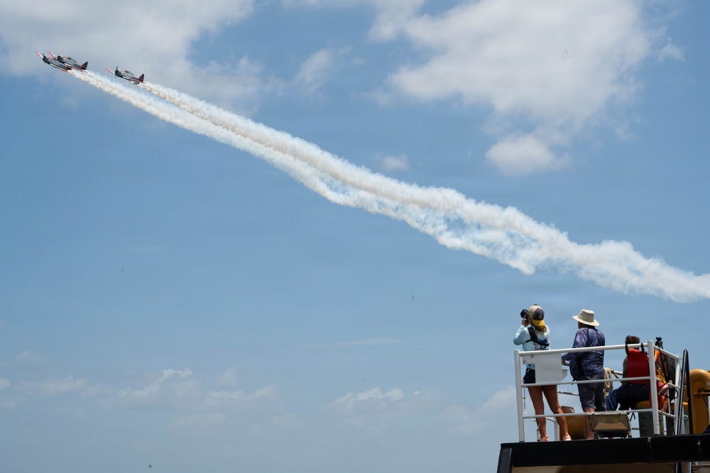 The Titan Aerobatic Team flies by the U.S. Coast Guard Cutter Barbara Mabrity
