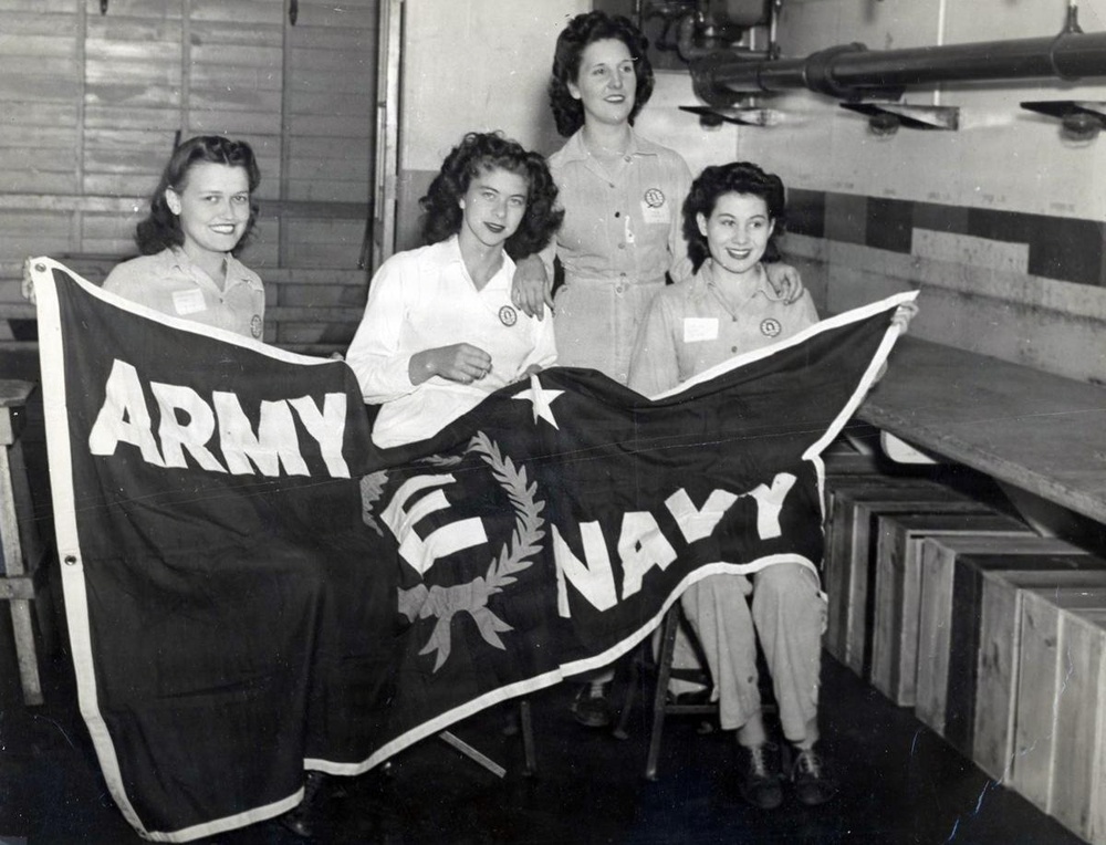 Historic photo of employees with Army/Navy flag at Radford Ordnance Works.