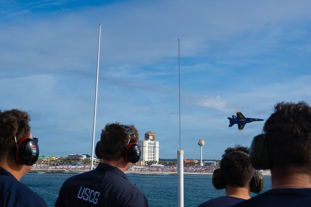 Members of the U.S. Coast Guard Cutter Barbara Mabrity watch as the U.S. Navy Blue Angels fly overhead