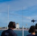 Members of the U.S. Coast Guard Cutter Barbara Mabrity watch as the U.S. Navy Blue Angels fly overhead