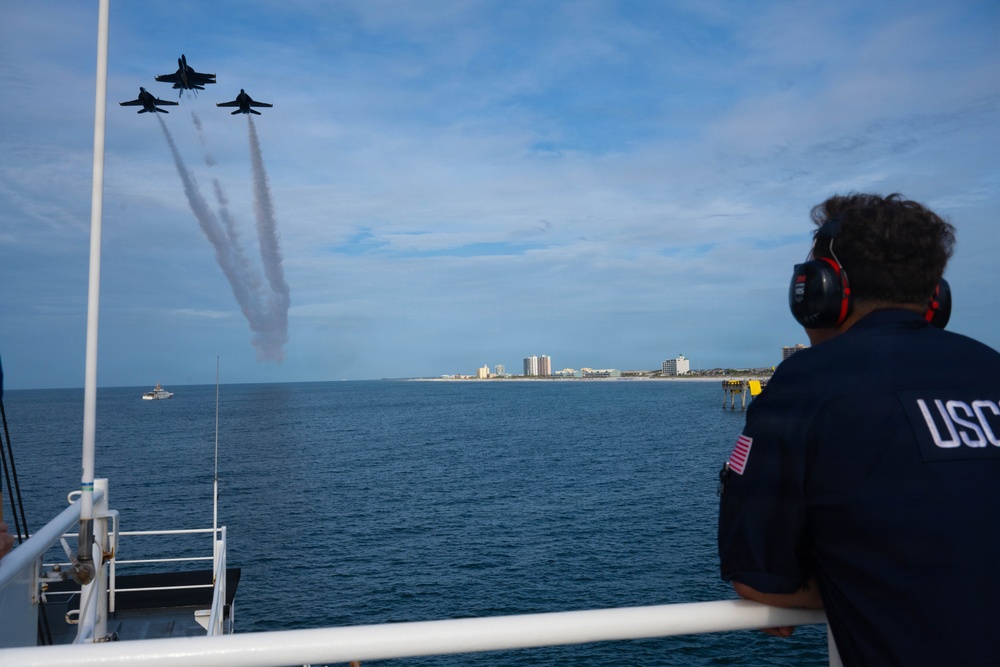 Members of the U.S. Coast Guard Cutter Barbara Mabrity watch as the U.S. Navy Blue Angels fly overhead