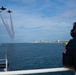 Members of the U.S. Coast Guard Cutter Barbara Mabrity watch as the U.S. Navy Blue Angels fly overhead