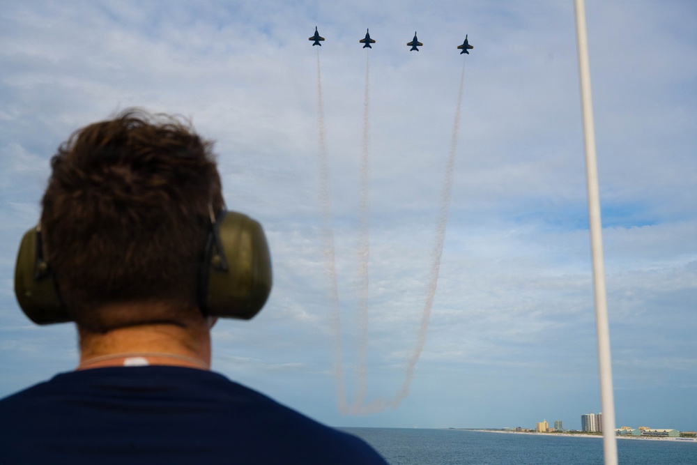 Members of the U.S. Coast Guard Cutter Barbara Mabrity watch as the U.S. Navy Blue Angels fly overhead
