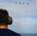 Members of the U.S. Coast Guard Cutter Barbara Mabrity watch as the U.S. Navy Blue Angels fly overhead
