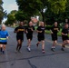 Senior officers conduct physical training during a visit from distinguished visitors at JBLM