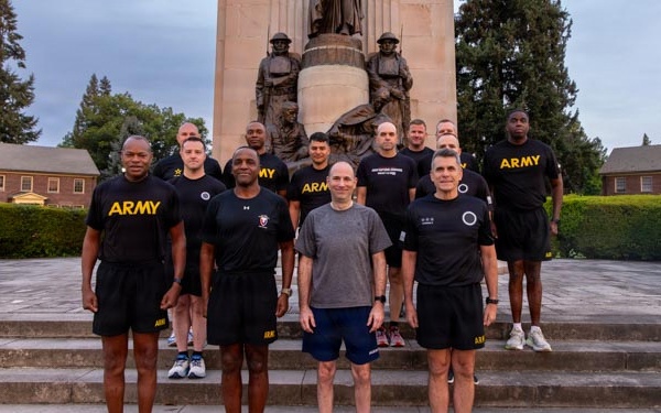 Senior officers conduct physical training during a visit from distinguished visitors at JBLM