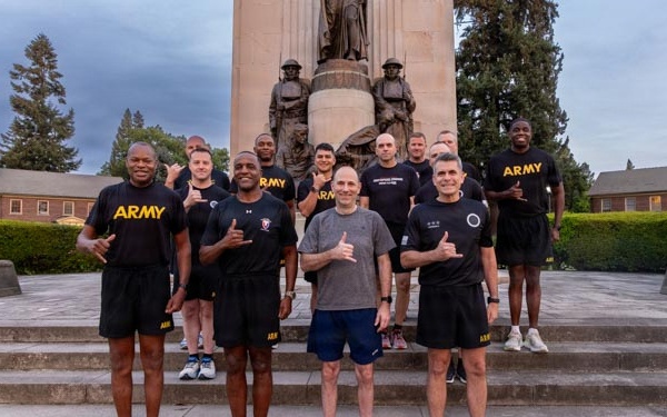 Senior officers conduct physical training during a visit from distinguished visitors at JBLM