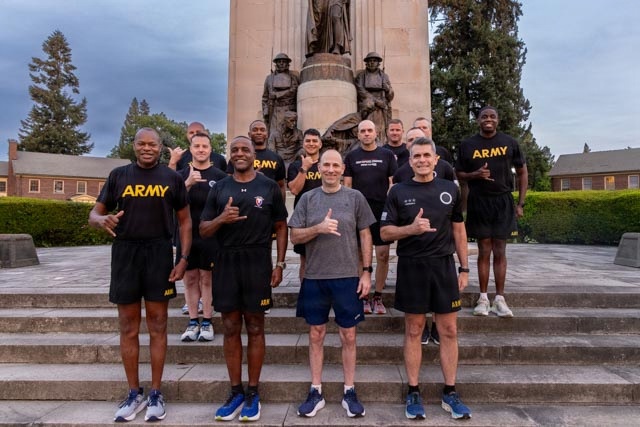 Senior officers conduct physical training during a visit from distinguished visitors at JBLM