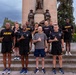 Senior officers conduct physical training during a visit from distinguished visitors at JBLM