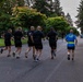 Senior officers conduct physical training during a visit from distinguished visitors at JBLM