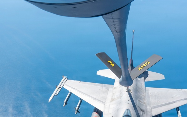 An aerial refueling operation is captured from the perspective of a tanker aircraft, showing an F-16 Fighting Falcon receiving fuel via a boom refueling system over open water. The fighter jet bears markings indicating it belongs to the Air National Guard (ANG) with a 'PA' designation, suggesting Pennsylvania Air National Guard. The aircraft is armed with multiple air-to-air missiles and external fuel tanks.