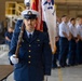 U.S. Coast Guard Color Guard member presents colors during ceremonial event inside hangar