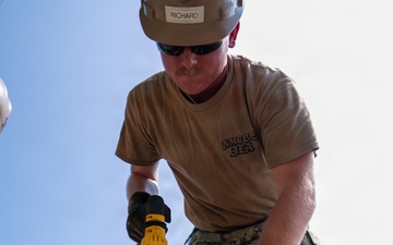 Naval Mobile Construction Battalion 5 Sailors clear damage and repair fence at Kojedo Aikwangwon in South Korea