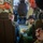 U.S. Marines, JMSDF Sailors reinforce maritime readiness during Rescue Flag 26-1 Military personnel are gathered inside what appears to be a military aircraft cabin, reviewing documents or maps together. At least two individuals in flight suits are seated and engaged in a briefing or mission planning session. Orange life vests are visible mounted overhead, consistent with a maritime patrol or transport aircraft interior.