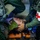 U.S. Marines, JMSDF Sailors reinforce maritime readiness during Rescue Flag 26-1 Military medical personnel are providing emergency care to a casualty secured on an orange stretcher. Two individuals in olive/green flight suits are attending to a patient who has a cervical collar applied, with one wearing blue medical gloves. A red cross medical pouch is visible on one responder's arm, indicating this is a military medical or combat casualty care scenario.