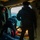 U.S. Marines, JMSDF Sailors reinforce maritime readiness during Rescue Flag 26-1 The image shows the interior of a military helicopter with personnel conducting what appears to be a maritime rescue or search-and-rescue operation. Three individuals are visible near the open side door of the aircraft, with one person in a wetsuit handling equipment on a yellow rescue raft or platform. A Japanese Maritime Self-Defense Force rising sun emblem is visible on equipment in the foreground.