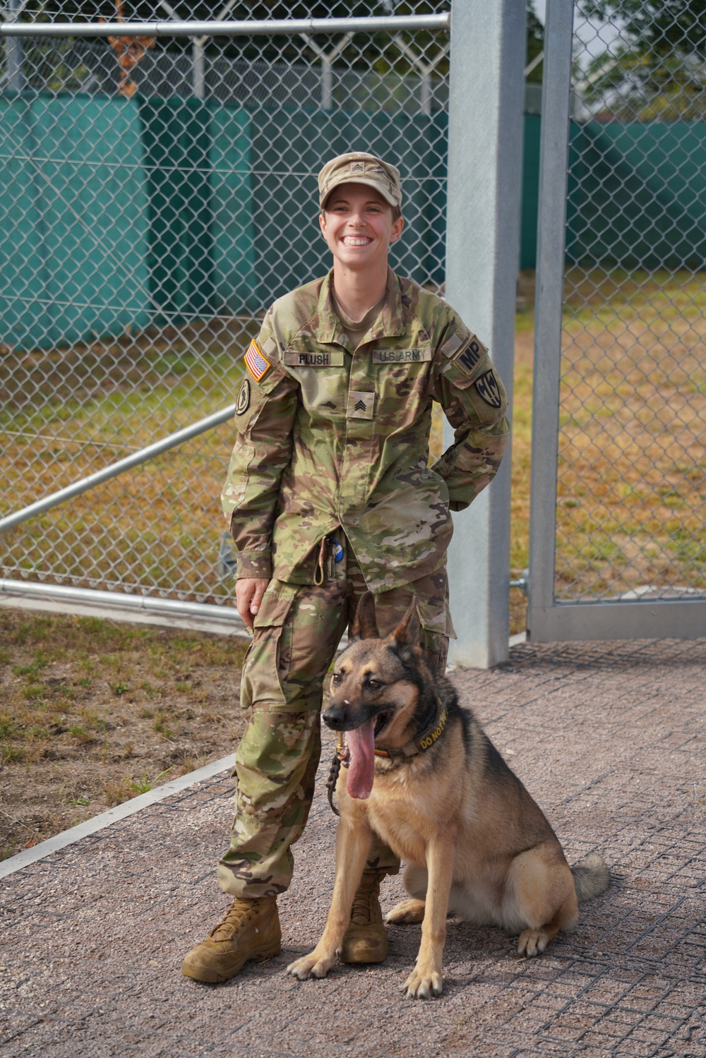 Sgt. Brianna Plush stands with Military Working Dog Edzsi