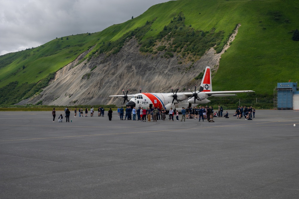 Coast Guard personnel compete to pull an HC-130J Super Hercules airplane in Kodiak, Alaska