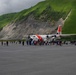 Coast Guard personnel compete to pull an HC-130J Super Hercules airplane in Kodiak, Alaska