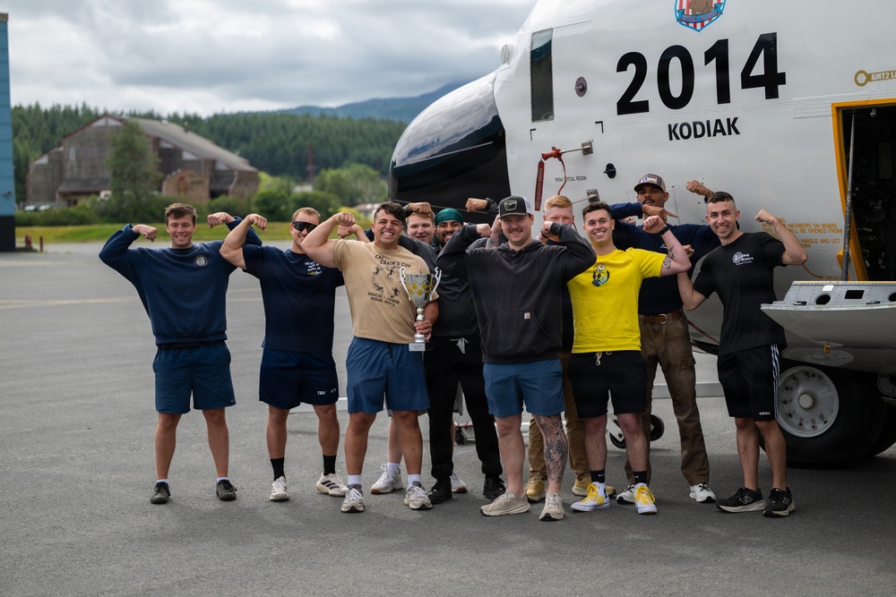 Coast Guard personnel compete to pull an HC-130J Super Hercules airplane in Kodiak, Alaska