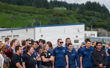 Coast Guard personnel compete to pull an HC-130J Super Hercules airplane in Kodiak, Alaska