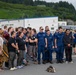 Coast Guard personnel compete to pull an HC-130J Super Hercules airplane in Kodiak, Alaska