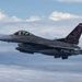 A U.S. Air Force F-16 Fighting Falcon jet fighter is photographed in flight above a cloud layer. The aircraft belongs to the 177th Fighter Wing (177FW) of the New Jersey Air National Guard, identifiable by the distinctive black and red tail markings with 'AC' tail code. The aircraft is armed and flying in formation, photographed from a nearby aircraft.