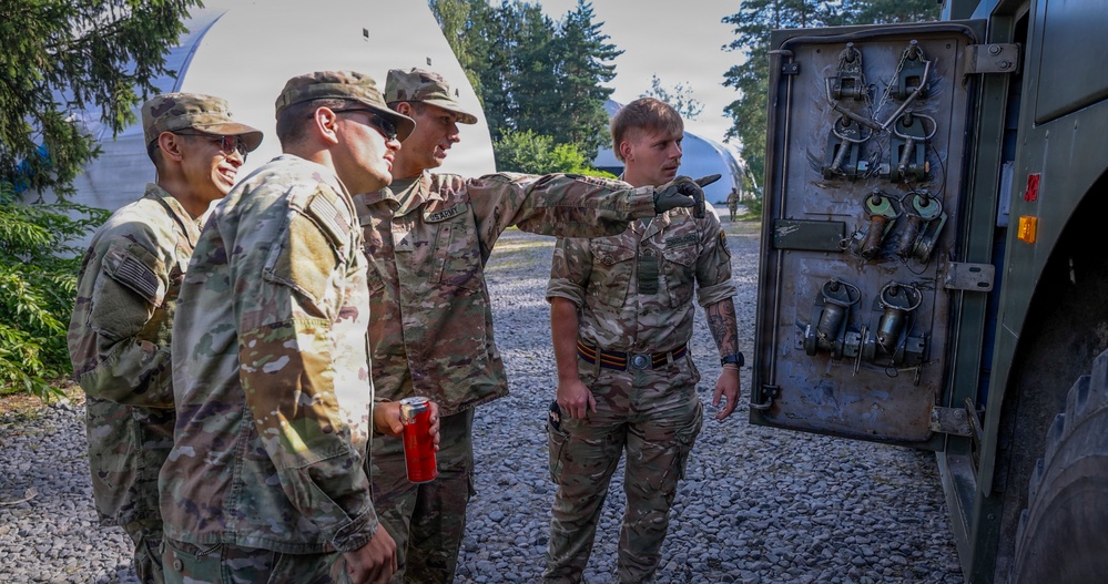 U.S. Soldiers cross train on vehicle recovery techniques with NATO allies in Poland