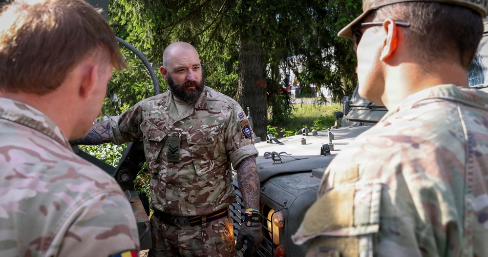 U.S. Soldiers cross train on vehicle recovery techniques with NATO allies in Poland