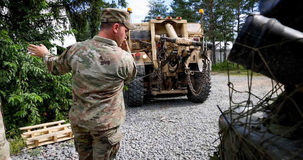 U.S. Soldiers cross train on vehicle recovery techniques with NATO allies in Poland