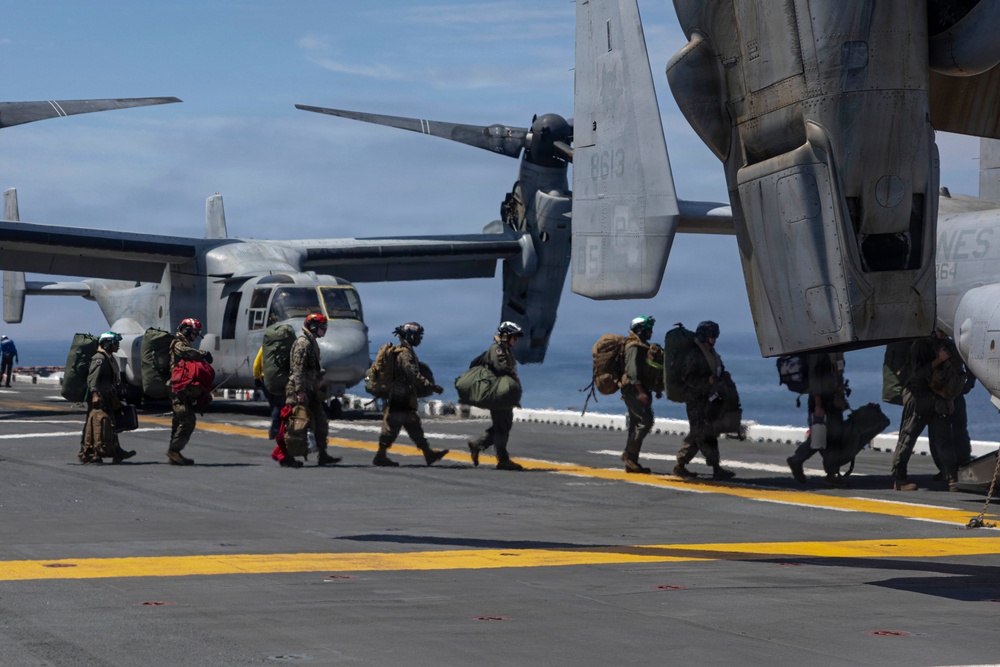 U.S Navy And Marine Corps Personnel Depart USS Makin Island
