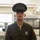 Alpha Company Battalion Commander’s Inspection A young male United States Marine is photographed in Service Alpha (Dress Green) uniform inside what appears to be a military barracks. He is wearing the rank insignia of a Private First Class (PFC) on both sleeves and a Rifle Expert badge on his chest. The image is a sharp, well-lit portrait-style photograph taken in an indoor military setting.