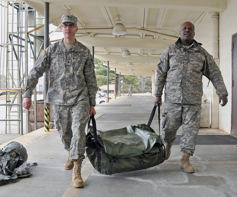 Army Spcs. Adam Schroeder (left) and Bernard Satchell