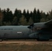 A U.S. Air Force C-130 Hercules military transport aircraft is taxiing or rolling on a runway or unpaved airstrip. The aircraft bears the markings 'U.S. AIR FORCE' and the tail number '4631' on its fuselage. The image was taken with a panning technique, resulting in motion blur in the background while the aircraft remains relatively sharp.