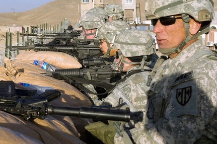 Servicemembers defend the wall after an improvised explosive device detonates on Forward Operating Base Lightning on Dec. 5, 2010. (U.S. Air Force photo by Staff Sgt. Jason Colbert) (Released)