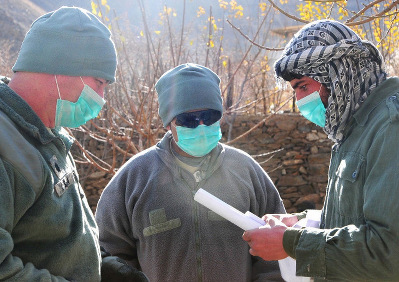 Army Lt. Col. Jeffrey Casada (left), Kentucky National Guard Agribusiness Development Team leader and London Ky. Native, and chicken farm entrepreneur Shanawaz Khan (right) speak through an interpreter in Khenj District on Dec. 12, 2010.