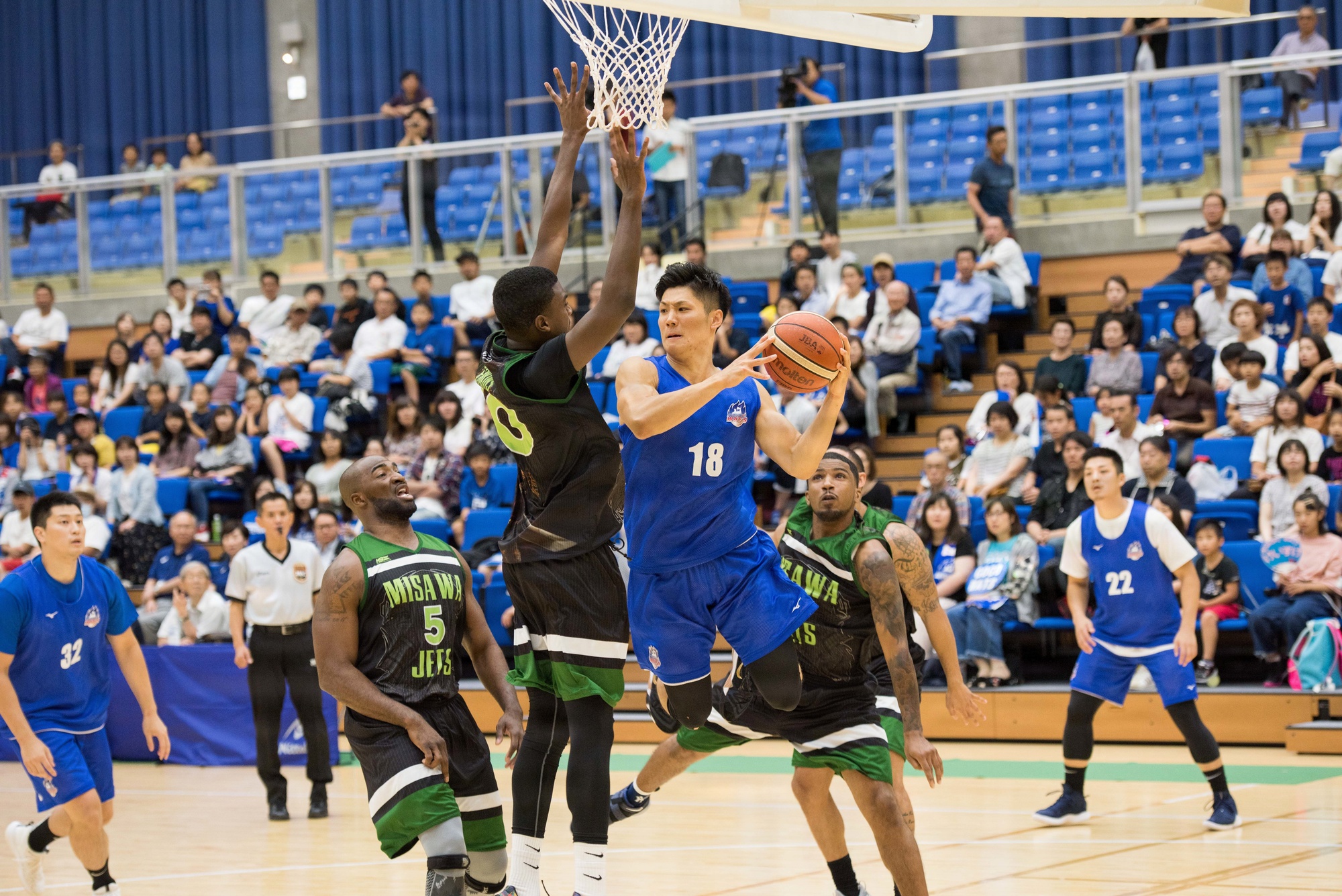 Myles Erkins, a Misawa Jets and 35th Force Support Squadron member, jumps in front of an Aomori Wat’s player preventing a layup during the two team’s exhibition game at the Misawa International Sports Center in Misawa City, Japan, Aug. 18, 2018. The game continues the city’s 60th Anniversary celebration. (U.S. Air Force photo by Tech. Sgt. Benjamin W. Stratton)